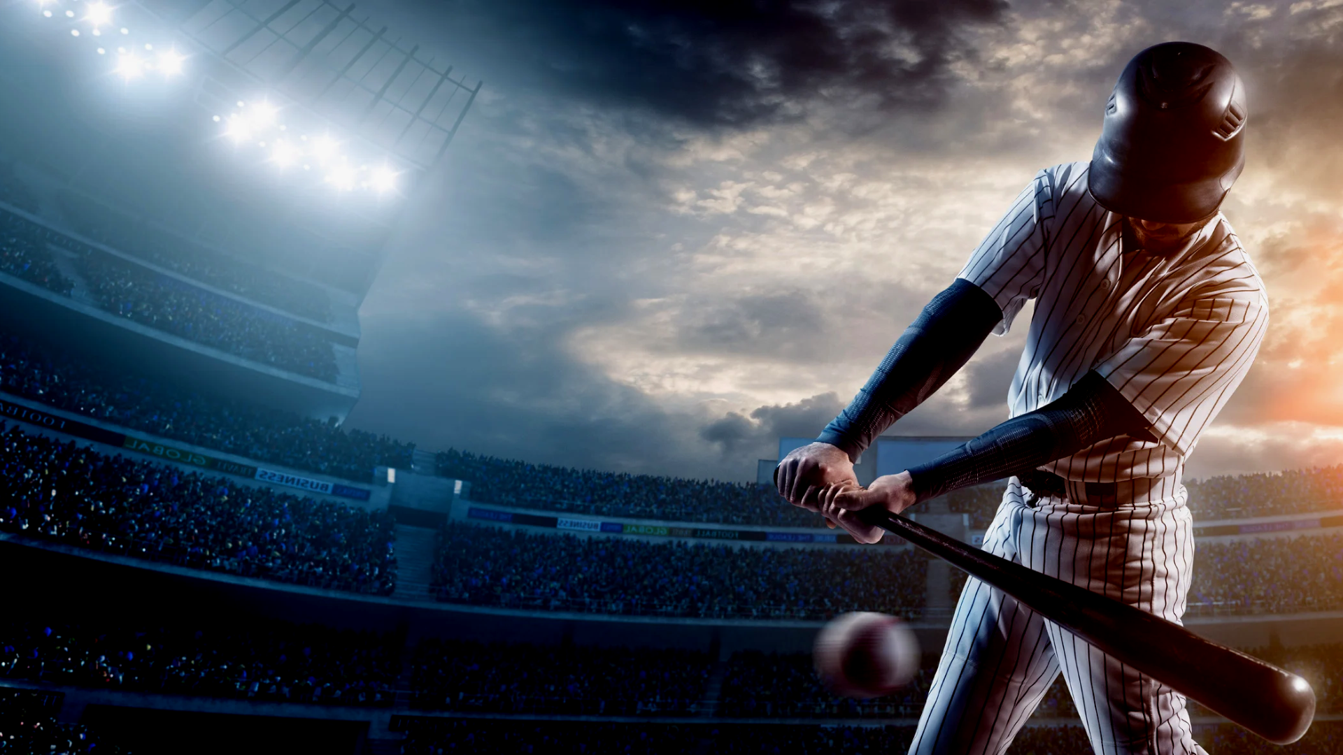 A Baseball player hitting a ball inside a major league stadium.