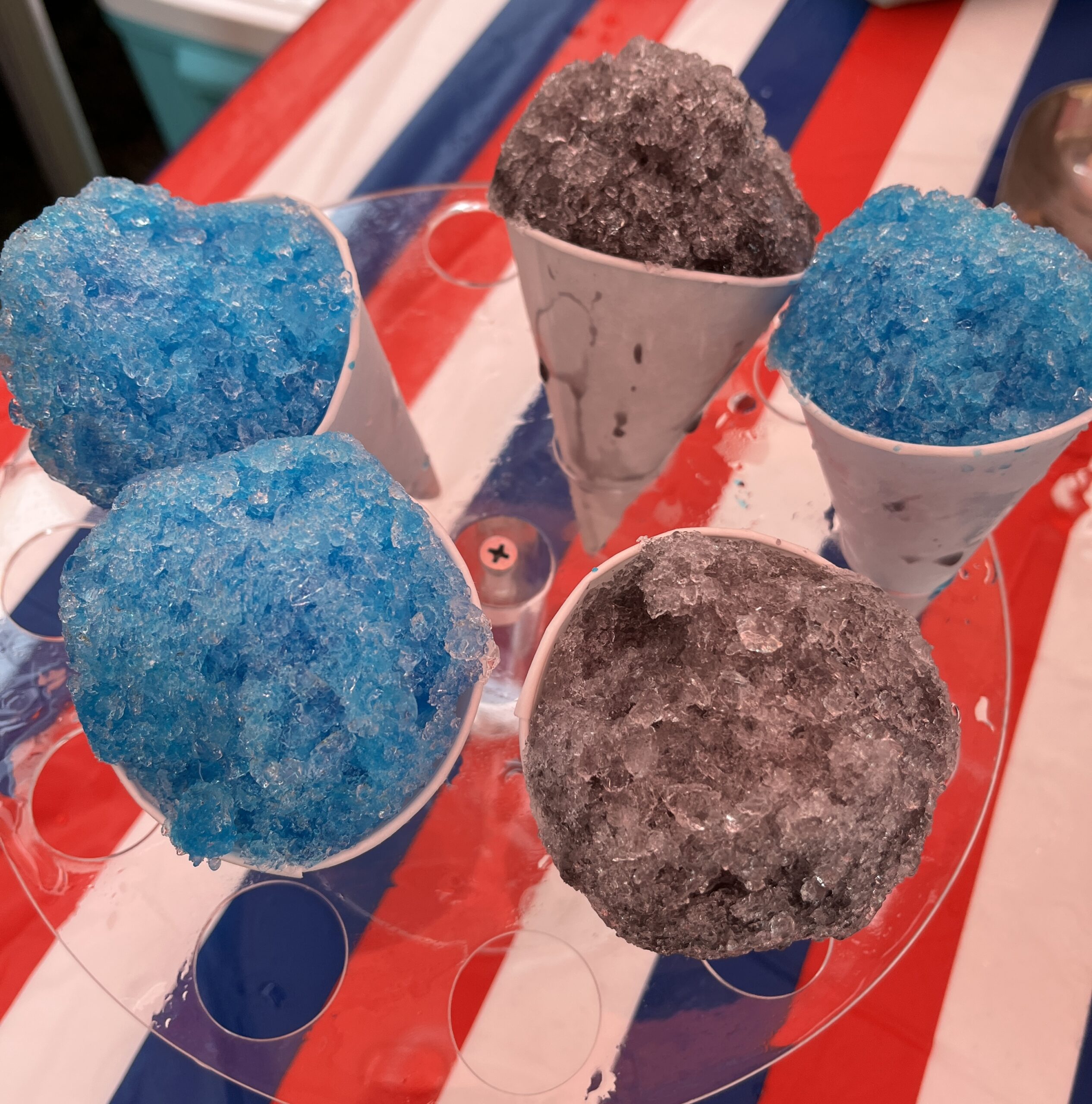 Blue and purple snow cones in a circle on a table
